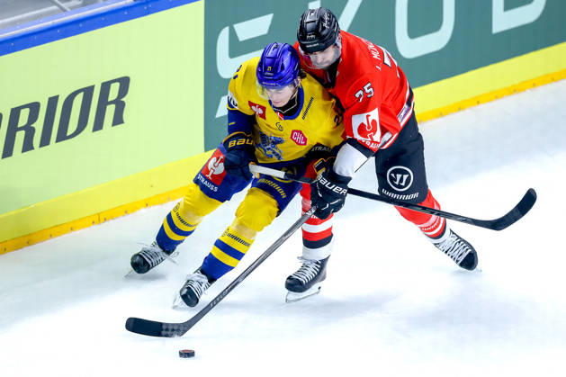 October 7, 2026, Ice Hockey, CHL, Kölner Haie vs. Blue Fox Herning, Champions Hockey League 2026–27, Matchday 5, 2026–27 Season, Lanxess Arena, Cologne; Hjalte Kruse Thomsen of Blue Fox Herning (No. 21) in a battle with Luca Münzenberger of Kölner Haie (No. 75); North Rhine-Westphalia, Germany