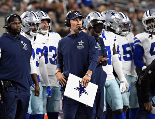 Dallas Cowboys head coach Berian Schottenheimer calls plays against the Tampa Bay Buccaneers during their game at AT&T Stadium in Arlington, Texas on Thursday, October 8, 2026. ARL2026100817 IANxHALPERIN