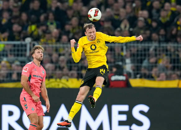 Maximilian Beier of Borussia Dortmund, No. 14, jumps for a header while Niclas Füllkrug of SV Werder Bremen, No. 10, looks on. GER, Borussia Dortmund vs. SV Werder Bremen, Bundesliga 1, Matchday 5, 2026–27 season, SIGNAL IDUNA PARK, Dortmund, October 9, 2026. DFL regulations prohibit any use of photographs as image sequences and or quasi-video. Borussia Dortmund vs. SV Werder Bremen, Bundesliga 1, Matchday 5, 2026–27 season, October 9, 2026, Dortmund Copyright: xEibner-Pressefoto ScottxColemanx EP_SCN