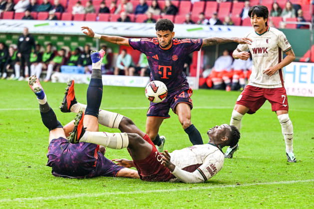 October 10, 2026, GER, Soccer, Men s, Bundesliga 1, Matchday 5, FC Augsburg vs. FC Bayern Munich: Luis Diaz (Bayern Munich), 14, in possession; Harry Kane (Bayern Munich), 9; and Juma Bah (FC Augsburg), 35, lying on their backs after a battle for the ball at the WWK Arena in Augsburg, Bavaria, Germany Copyright: xNordphotox xHafnerx