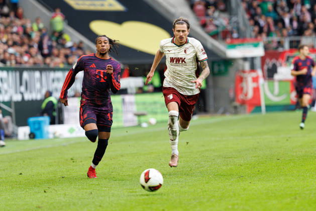 Michael Olise, 17, FC Bayern Munich, and Calvin Brackelmann, 2, FC Augsburg, during the match between FC Augsburg and FC Bayern Munich, soccer, men s, Bundesliga, 2026–2027, Matchday 5 on October 10, 2026, in Augsburg, WWK ARENA. DFL and DFB regulations prohibit any use of photographs as image sequences and or quasi-video. Bayern, Germany