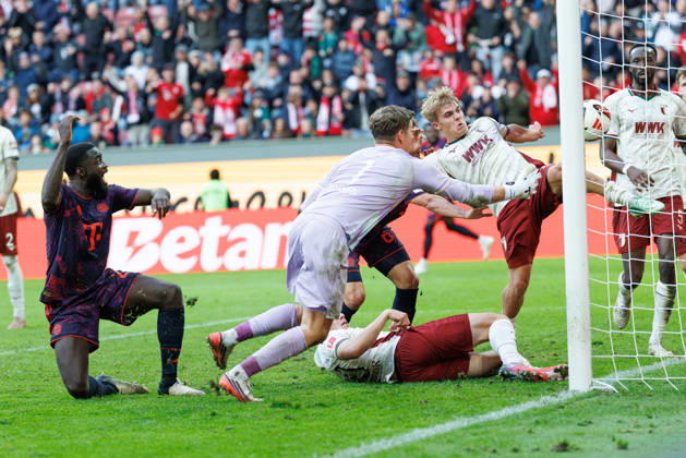 Hennes Behrens (16), FC Augsburg, and Finn Dahmen (1), FC Augsburg, make a save on the goal line during the match between FC Augsburg and FC Bayern Munich, soccer, men’s, Bundesliga, 2026–2027, Matchday 5 on October 10, 2026, in Augsburg, WWK ARENA. DFL and DFB regulations prohibit any use of photographs as image sequences and or quasi-video. Bavaria, Germany
