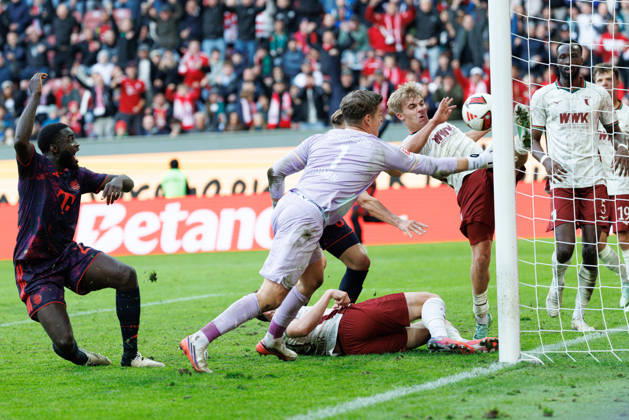 Hennes Behrens (16), FC Augsburg, and Finn Dahmen (1), FC Augsburg, make a save on the goal line during the match between FC Augsburg and FC Bayern Munich, soccer, men’s, Bundesliga, 2026–2027, Matchday 5 on October 10, 2026, in Augsburg, WWK ARENA. DFL and DFB regulations prohibit any use of photographs as image sequences and or quasi-video. Bavaria, Germany