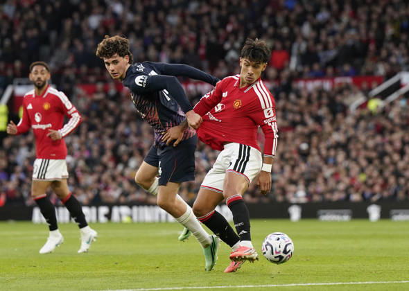 Manchester, England, 10th October 2026. Archie Gray of Tottenham tussles with Lisandro Martinez of Manchester United, ManU during the Manchester United vs Tottenham Hotspur Premier League match at Old Trafford, Manchester. Picture credit should read: Andrew Yates Sportimage EDITORIAL USE ONLY. No use with unauthorised audio, video, data, fixture lists, club league logos or live services. Online in-match use limited to 120 images, no video emulation. No use in betting, games or single club league player publications. SPI_032_AY_MANUTD_SPURS SPI-5058-0032