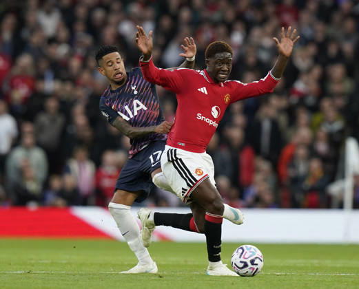 Manchester, England, 10th October 2026. Savio of Tottenham tackles Kobbie Mainoo of Manchester United, ManU during the Manchester United vs Tottenham Hotspur Premier League match at Old Trafford, Manchester. Picture credit should read: Andrew Yates Sportimage EDITORIAL USE ONLY. No use with unauthorised audio, video, data, fixture lists, club league logos or live services. Online in-match use limited to 120 images, no video emulation. No use in betting, games or single club league player publications. SPI_038_AY_MANUTD_SPURS SPI-5058-0038