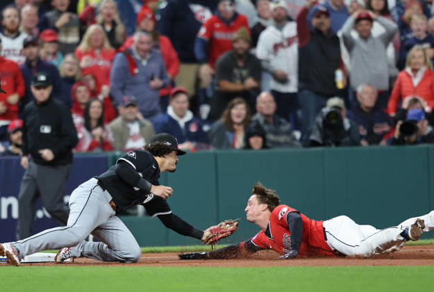 Cleveland Guardians Petey Halpin (0) is tagged out at third by Chicago White Sox third baseman Miguel Vargas (20) after trying to stretch a double into a triple in the fifth inning of an MLB, Baseball Herren, USA American League Division Series at Progressive Field in Cleveland, Ohio, on Saturday, October 10, 2026.  CLE20261010726 AARONxJOSEFCZYK