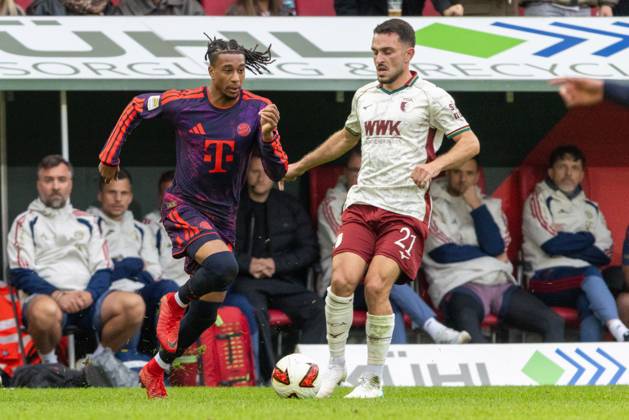 Michael Olise of FC Bayern Munich and Arijon Ibrahimovic of FC Augsburg in a one-on-one duel, FC Augsburg vs. FC Bayern Munich, Bundesliga Soccer, Soccer, Bundesliga 1, Matchday 5, October 10, 2026. DFL regulations prohibit any use of photographs as image sequences and or quasi-video. Copyright: xkolbert-press PeterxFastlx