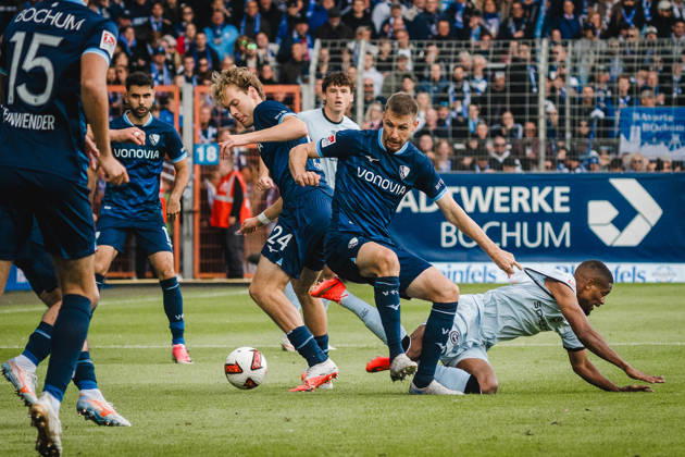 Bochum, Germany, October 11, 2026; 2. Bundesliga 2026–2027, Matchday 7: VfL Bochum 1848 vs. DSC Arminia Bielefeld. Pictured, from left, in a tackle: Mats Pannewig (BOC), Karol Mets (BOC), and Isaiah Young (DSC). DFL and DFB regulations prohibit any use of photographs as image sequences and or quasi-video. Vonovia Ruhrstadion, North Rhine-Westphalia Copyright: xFotostandx xGraebex
