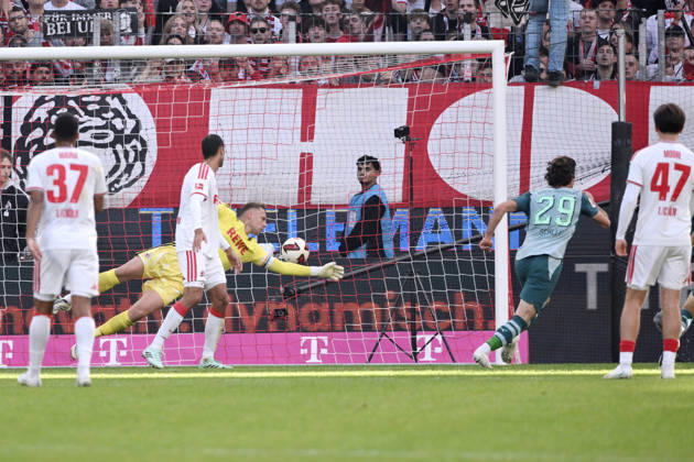 Joe Scally of Borussia Mönchengladbach (right) scores against goalkeeper Marvin Schwäbe of 1. FC Köln, tying the game at 1–1 on October 11, 2026, in the 1. Bundesliga, 2026–2027 season, Matchday 5, 1. FC Köln vs. Borussia Mönchengladbach. DFL regulations prohibit any use of photographs as image sequences and or quasi-video. Cologne, RheinEnergie Stadium, North Rhine-Westphalia, Germany Team2