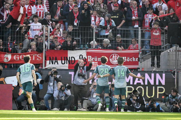 Joe Scally of Borussia Mönchengladbach, center, celebrates in front of the Cologne fan section; in the background, a photographer makes an offensive gesture. October 11, 2026, Soccer, Bundesliga, 2026–2027 season, Matchday 5, 1. FC Köln vs. Borussia Mönchengladbach. DFL regulations prohibit any use of photographs as image sequences and or quasi-video. Cologne, RheinEnergie Stadium, North Rhine-Westphalia, Germany Team2