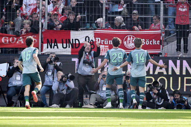 Joe Scally of Borussia Mönchengladbach, center, celebrates in front of the Cologne fan section; in the background, a photographer makes an offensive gesture. October 11, 2026, Soccer, Bundesliga, 2026–2027 season, Matchday 5, 1. FC Köln vs. Borussia Mönchengladbach. DFL regulations prohibit any use of photographs as image sequences and or quasi-video. Cologne, RheinEnergie Stadium, North Rhine-Westphalia, Germany Team2