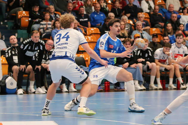 11 10 2026 Men s Handball 2026–2027, 2nd Division, Matchday 7: Dessau Roßlauer HV 06 vs. VfL Lübeck Schwartau at Anhalt Arena, Dessau. Marcel Nowak, Dessau, 15, in blue with the ball; Thore Heinemann, Lübeck, 34, in white, closes down the space; Dessau Roßlau, Saxony-Anhalt, Germany
