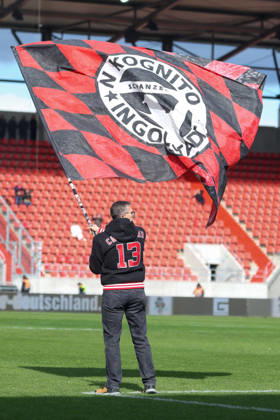Ingolstadt, Germany, October 11, 2026; 3. Liga 2026–2027, Matchday 8: FC Ingolstadt 04 vs. SV Wehen Wiesbaden. Pictured: A fan waving a flag on the field, Flag waver: DFB and DFL regulations prohibit any use of photographs as image sequences and or quasi-video Copyright: xFotostandx xSchäferx