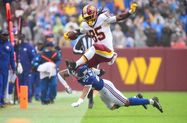LANDOVER, MD - OCTOBER 11: Commanders tight end Chig Okonkwo (85) hurdles a tackle by Giants cornerback Greg Newsome II (20) at the end of a long first half catch and run during the New York Giants versus Washington Commanders National Football League game at Northwest Stadium on October 11, 2026 in Landover, MD. (Photo by Randy Litzinger Icon Sportswire) NFL, American Football Herren, USA OCT 11 Giants at Commanders EDITORIAL USE ONLY Icon9662610110485