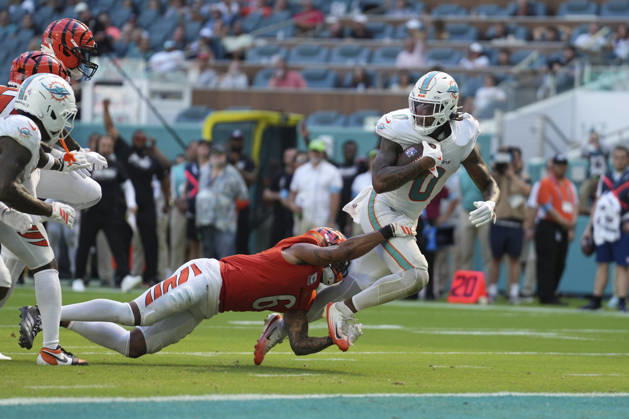 MIAMI GARDENS, FL - OCTOBER 11: Miami Dolphins running back Ollie Gordon II (0) tries to get into the end zone as Cincinnati Bengals safety Bryan Cook (6) makes the stop during the NFL, American Football Herren, USA game between the Cincinnati Bengals and the Miami Dolphins on Sunday, October 11, 2026 at Hard Rcok Stadium in Miami Gardens, FL (Photo by Peter Joneleit Icon Sportswire) NFL: OCT 11 Bengals at Dolphins EDITORIAL USE ONLY Icon2601011012