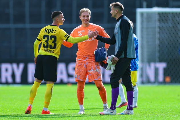 GC Zurich vs. BSC Young Boys, Brack Super League, October 11, 2026: Stefan Bukinac (33), BSC Young Boys (left), Marvin Hübel (1), Grasshopper Club Zurich, and Joël Mall (18), BSC Young Boys in the Brack Super League match between Grasshopper Club Zurich (GCZ) and BSC Young Boys (YB) on October 11, 2026, at Letzigrund Stadium in Zurich, Switzerland; Zurich, Letzigrund Stadium, Zurich, Switzerland