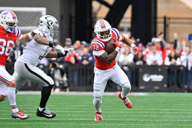Oct 11, 2026; Foxborough, MA, USA; New England Patriots running back TreVeyon Henderson (32) runs the ball with pressure from Las Vegas Raiders linebacker Nakobe Dean (17) during the first half at Gillette Stadium. Mandatory Credit: -Cal Media Foxborough USA - ZUMAc04_ 20261011_zma_c04_145 Copyright: xEricxCanhax