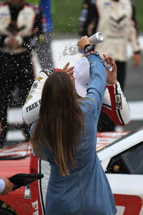 CHARLOTTE, NC - OCTOBER 11: Chase Briscoe ( 19 Joe Gibbs Racing Freebird Spring Water Toyota) celebrates as his wife Marissa pours water on his head after winning the NASCAR, Motorsport, USA Cup Series Playoffs Bank of America 400 race on October 11, 2026 at Charlotte Motor Speedway in Charlotte, NC. (Photo by Jeff Robinson Icon Sportswire) AUTO: OCT 11 NASCAR Cup Series Playoffs Bank of America 400 EDITORIAL USE ONLY Icon2610111035400