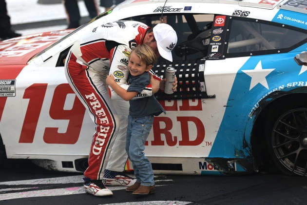 CHARLOTTE, NC - OCTOBER 11: Chase Briscoe ( 19 Joe Gibbs Racing Freebird Spring Water Toyota) celebrates with his son Brooks after winning the NASCAR, Motorsport, USA Cup Series Playoffs Bank of America 400 race on October 11, 2026 at Charlotte Motor Speedway in Charlotte, NC. (Photo by Jeff Robinson Icon Sportswire) AUTO: OCT 11 NASCAR Cup Series Playoffs Bank of America 400 EDITORIAL USE ONLY Icon261011856400