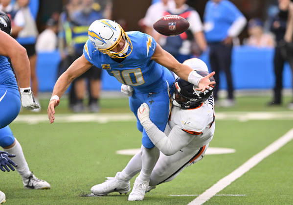 INGLEWOOD, CA - OCTOBER 11: Denver Broncos defensive tackle D.J. Jones (93) tackles Los Angeles Chargers quarterback Justin Herbert (10) while knocking the ball loose during the game between the Los Angeles Chargers and the Denver Broncos on October 11, 2026 at SoFi Stadium in Inglewood. (Photo by David Dennis Icon Sportswire) NFL, American Football Herren, USA OCT 11 Broncos at Chargers EDITORIAL USE ONLY Icon26101146