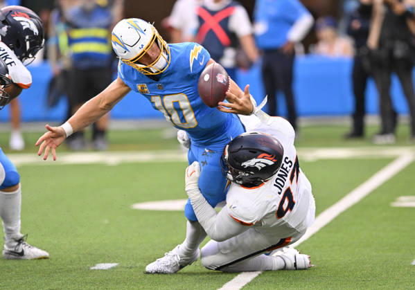 INGLEWOOD, CA - OCTOBER 11: Denver Broncos defensive tackle D.J. Jones (93) tackles Los Angeles Chargers quarterback Justin Herbert (10) while knocking the ball loose during the game between the Los Angeles Chargers and the Denver Broncos on October 11, 2026 at SoFi Stadium in Inglewood. (Photo by David Dennis Icon Sportswire) NFL, American Football Herren, USA OCT 11 Broncos at Chargers EDITORIAL USE ONLY Icon26101147