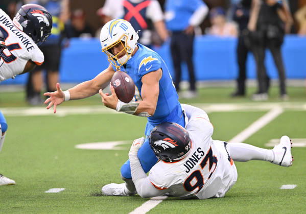 INGLEWOOD, CA - OCTOBER 11: Denver Broncos defensive tackle D.J. Jones (93) tackles Los Angeles Chargers quarterback Justin Herbert (10) while knocking the ball loose during the game between the Los Angeles Chargers and the Denver Broncos on October 11, 2026 at SoFi Stadium in Inglewood. (Photo by David Dennis Icon Sportswire) NFL, American Football Herren, USA OCT 11 Broncos at Chargers EDITORIAL USE ONLY Icon26101148