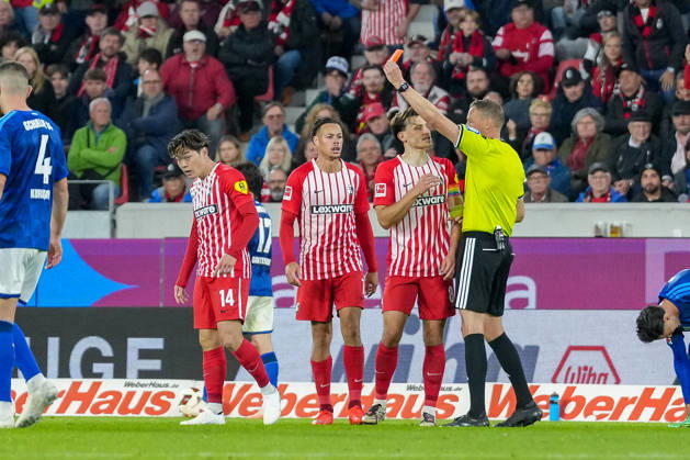 Referee Martin Petersen shows Yuito Suzuki of SC Freiburg, No. 14, a yellow-red card, resulting in his ejection from the game; Germany, soccer, Bundesliga 1, Matchday 5, 2026–2027, SC Freiburg vs. FC Schalke 04, October 11, 2026, Europa-Park Stadium, Freiburg, Baden-Württemberg, Germany Copyright: xArnexAmbergx