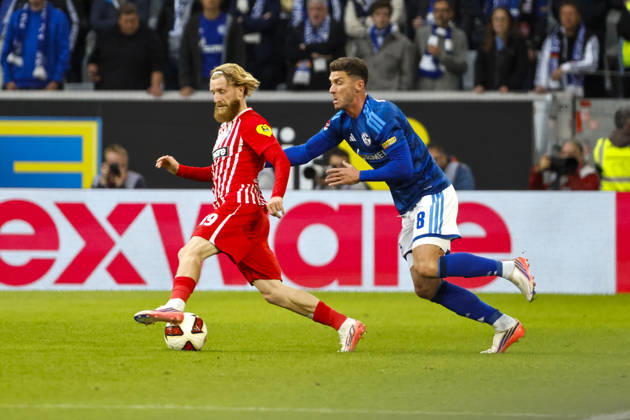 Niklas Beste of SC Freiburg, 19, and Robin Gosens of FC Schalke 08 in a tackle, Germany, soccer, Bundesliga 1, Matchday 5, 2026–2027, SC Freiburg vs. FC Schalke 04, October 11, 2026, Freiburg im Breisgau, Europa-Park Stadium, Germany Copyright: xGrantxHubbsx