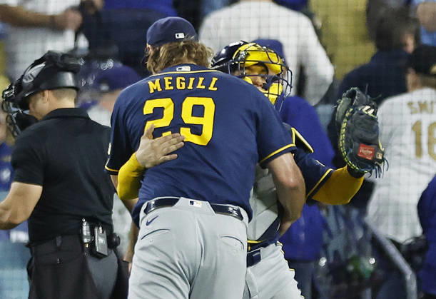 Milwaukee Brewers pitcher Trevor Megill (29) celebrates with catcher William Contreras (24) after the Brewers defeated the Los Angeles Dodgers 6-2 in game three of the MLB, Baseball Herren, USA National League Championship Series playoffs at Dodger Stadium in Los Angeles, California, on Wednesday, October 14, 2026. The Brewers have a 3-0 lead in the best-of-seven series.  LAP20261014745 CAROLINExBREHMAN