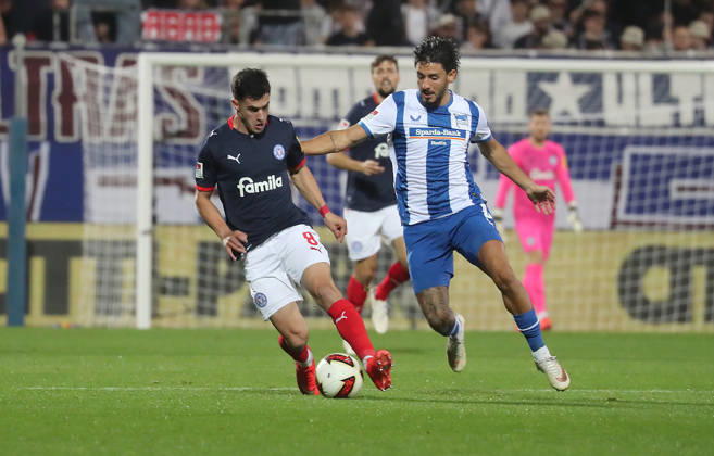 Guillermo Balzi, Holstein Kiel; Kevin Sessa, Hertha BSC Berlin; Soccer, Men s, 2026–2027 Season, 2. Bundesliga, Holstein Stadium, Holstein Kiel vs. Hertha BSC Berlin. DFL regulations prohibit any use of photographs as image sequences and or quasi-video.
