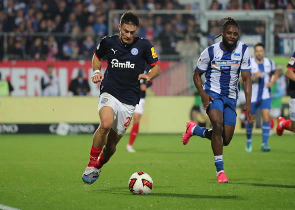 Adrian Kapralik, Holstein Kiel; Deyovaisio Zeefuik, Hertha BSC Berlin; Soccer, Men s, 2026–2027 Season, 2. Bundesliga, Holstein Stadium, Holstein Kiel vs. Hertha BSC Berlin. DFL regulations prohibit any use of photographs as image sequences and or quasi-video.