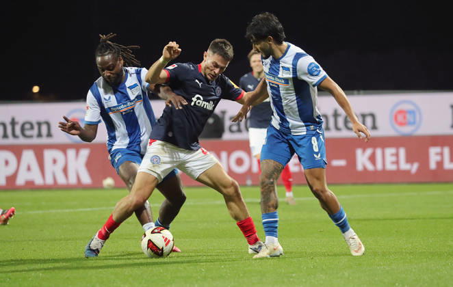 Deyovaisio Zeefuik, Hertha BSC Berlin; Adrian Kapralik, Holstein Kiel; Kevin Sessa, Hertha BSC Berlin; Soccer, Men s, 2026–2027 Season, 2. Bundesliga, Holstein Stadium, Holstein Kiel vs. Hertha BSC Berlin DFL REGULATIONS PROHIBIT ANY USE OF PHOTOGRAPHS AS IMAGE SEQUENCES AND OR QUASI-VIDEO