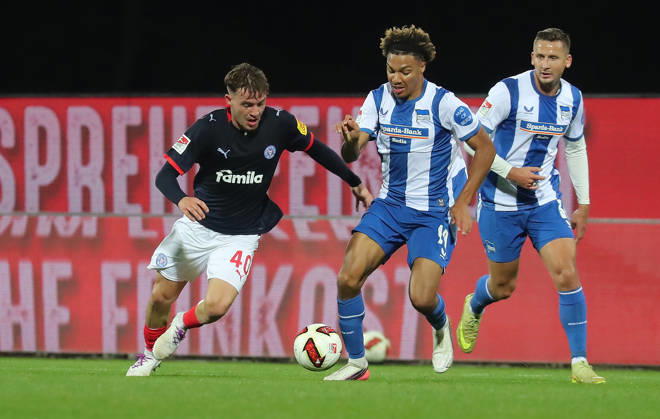 Leon Parduzi, Holstein Kiel; Oluwaseun Adewumi, Hertha BSC Berlin; Soccer, Men s, 2026–2027 Season, 2. Bundesliga, Holstein Stadium, Holstein Kiel vs. Hertha BSC Berlin, 0–0. DFL regulations prohibit any use of photographs as image sequences and or quasi-video.