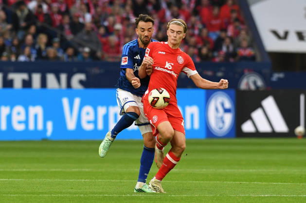 Kenan Karaman of FC Schalke 04 and Kacper Potulski of 1. FSV Mainz 05 in a tackle during the Bundesliga match between FC Schalke 04 and 1. FSV Mainz 05, Veltins Arena on October 17, 2026, in Gelsenkirchen, Germany. Photo by Ralf Treese, DeFodi Images. Kenan Karaman of FC Schalke 04 and Kacper Potulski of 1. FSV Mainz 05 battle for the ball during the Bundesliga match between FC Schalke 04 and 1. FSV Mainz 05 at Veltins Arena on October 17, 2026 in Gelsenkirchen, Germany. Photo by Ralf Treese, DeFodi Images. DFB and DFL regulations prohibit any use of photographs as image sequences and or quasi-video. Photo by Ralf Treese, DeFodi Images.