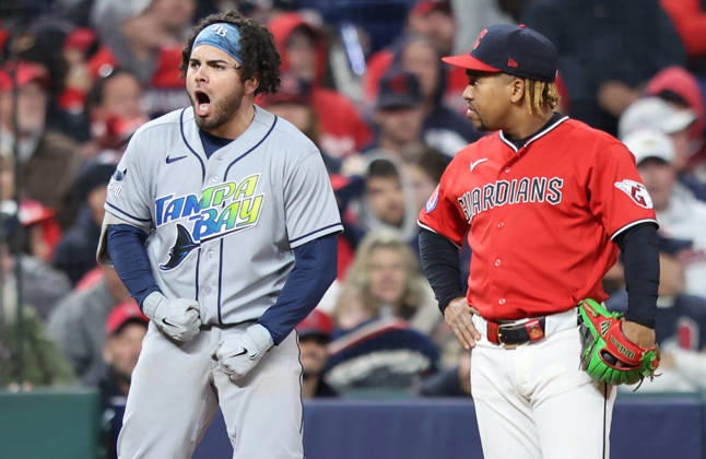 Tampa Bay Rays Jonathan Aranda (8) celebrates on third base next to Cleveland Guardians third baseman Jose Ramirez (11) after hitting a two-rbi single then advancing to third on a fielding error by Guardians right fielder Chase DeLauter in the seventh inning during game four of the MLB, Baseball Herren, USA American League Championship Series at Progressive Field in Cleveland, Ohio, on Saturday, October 17, 2026.  CLE20261017730 AARONxJOSEFCZYK