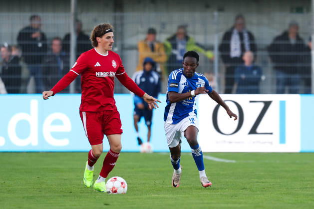 October 17, 2026, Soccer, Men s, Regionalliga Nord, Matchday 14, BSV Kickers Emden 1 FC Phönix Lübeck Michael Igwe (18) of BSV Kickers Emden in a tackle with Moritz Kretzer (14) of Phönix Lübeck