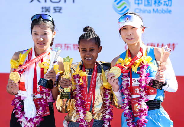 (261018) -- BEIJING, Oct. 18, 2026 -- (L to R)Second-placed Cirencuomu of China, first-placed Anchinalu Dessie Genaneh of Ethiopia and third-placed Lu Ying of China pose during the awarding ceremony for the women s marathon event at the 2026 Beijing Marathon & National Marathon Championships in Beijing, capital of China, Oct. 18, 2026. ) (SP)CHINA-BEIJING-2026 BEIJING MARATHON (CN) LuoxYuan 
