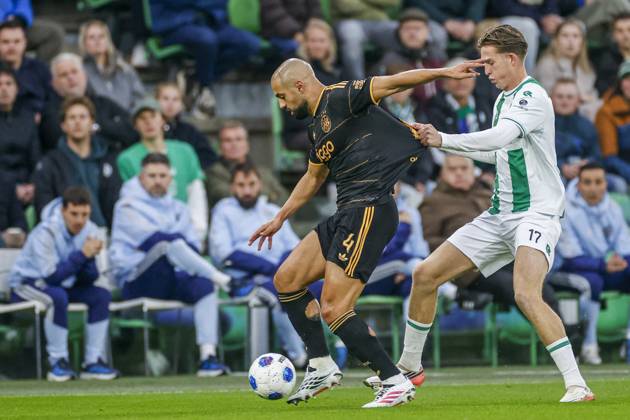 GRONINGEN , 18-10-2026 , Euroborg Stadium, season 2026 2027 , Dutch Eredivisie Football , match between FC Groningen and Ajax. Picture shows Ajax player Sofyan Amrabat and FC Groningen player David van der Werff Groningen - Ajax  x208697658x Copyright:
