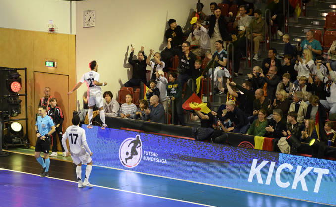 Matias Block (GER) celebrates after scoring the goal that made it 4–2, jumping onto the boards in front of the fans. Futsal World Cup Qualifier: Germany vs. Lithuania, 4–2, on October 18, 2026, in Mülheim an der Ruhr, Germany, at the Westenergie Sporthalle.