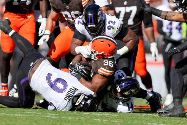 CLEVELAND, OH - OCTOBER 18: Cleveland Browns running back Audric Estime (36) is tackled by Baltimore Ravens linebacker Zion Young (9), Baltimore Ravens defensive tackle Nnamdi Madubuike (92), and Baltimore Ravens safety Kyle Hamilton (14) during the fourth quarter of the National Football League game between the Baltimore Ravens and Cleveland Browns on October 18, 2026, at Huntington Bank Field in Cleveland, OH. (Photo by Frank Jansky Icon Sportswire) NFL, American Football Herren, USA OCT 18 Ravens at Browns EDITORIAL USE ONLY Icon261018034