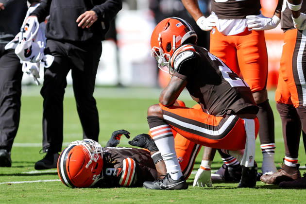 CLEVELAND, OH - OCTOBER 18: Cleveland Browns safety Grant Delpit (9) lays on the ground after a play as Cleveland Browns cornerback Denzel Ward (21) checks on him during the first quarter of the National Football League game between the Baltimore Ravens and Cleveland Browns on October 18, 2026, at Huntington Bank Field in Cleveland, OH. (Photo by Frank Jansky Icon Sportswire) NFL, American Football Herren, USA OCT 18 Ravens at Browns EDITORIAL USE ONLY Icon261018039