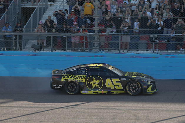 AVONDALE, AZ - OCTOBER 18: Tyler Reddick ( 45 23XI Racing ROCKSTAR ENERGY DRINK Toyota) burns out after winning the NASCAR, Motorsport, USA Cup Series Playoffs Freeway Insurance 500 on October 18, 2026, at Phoenix Raceway in Avondale, AZ. (Photo by Kevin Abele Icon Sportswire) AUTO: OCT 18 NASCAR Cup Series Playoffs Freeway Insurance 500 EDITORIAL USE ONLY Icon261018003500