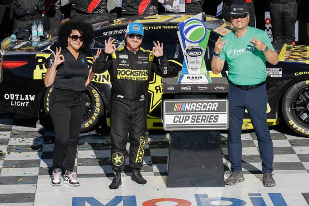 AVONDALE, AZ - OCTOBER 18: Tyler Reddick ( 45 23XI Racing ROCKSTAR ENERGY DRINK Toyota) celebrates with the trophy after winning the NASCAR, Motorsport, USA Cup Series Playoffs Freeway Insurance 500 on October 18, 2026, at Phoenix Raceway in Avondale, AZ. (Photo by Kevin Abele Icon Sportswire) AUTO: OCT 18 NASCAR Cup Series Playoffs Freeway Insurance 500 EDITORIAL USE ONLY Icon261018011500