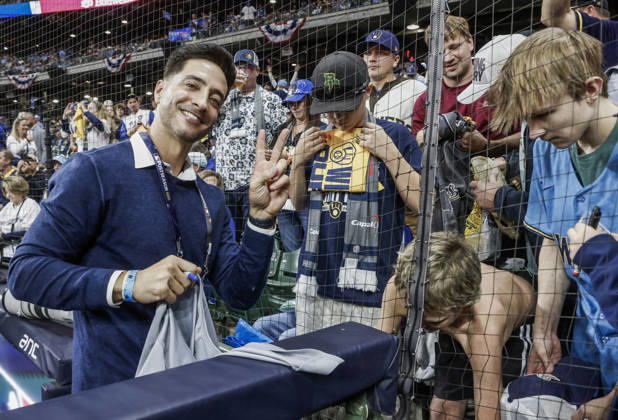 Former Brewers outfielder Ryan Braun poses as he signs autographs for fans before the start of game one of the 2026 World Series between the Tampa Bay Rays and the Milwaukee Brewers at American Family Field in Milwaukee, Wisconsin on Friday, October 23, 2026.  MIL20261023812 TANNENxMAURY