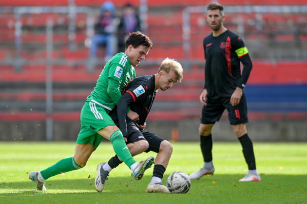 From left: Leon Stauber (Ansbach), 27; Andy Breuer (Unterhaching), 26, in a one-on-one battle, duel, tackle, dynamic action; Alexander Winkler (Unterhaching), 4, watching the scene; 24, 10, 2026, Unterhaching, Germany, soccer, Bavarian Regional League, SpVgg Unterhaching vs. SpVgg Ansbach xslx