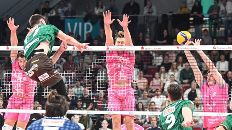 From left: Stijn van Schie (WWK Volleys Munich, No. 16) spikes the ball against the block set by Robert Viiber (Powervolleys Düren, No. 16) and Robin Baghdady (Powervolleys Düren, No. 8), 24, October 10, 2026, Düren, Germany, Volleyball, Men’s Bundesliga 1, Regular Season, SWD Powervolleys Düren vs. WWK Volleys Munich xmhx
