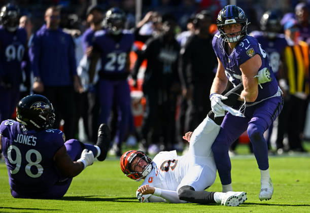 Cincinnati Bengals quarterback Joe Burrow (9) is stopped for no gain by Baltimore Ravens linebacker Ethan Burke (97) and defensive lineman Travis Jones (98) during the first quarter at M&T Bank Stadium in Baltimore, Maryland, on Sunday, October 25, 2026.  BAL20261025104 DAVIDxTULIS