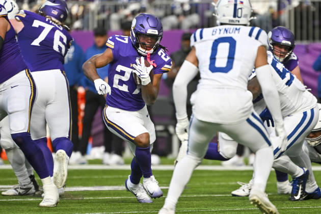Minnesota Vikings running back Jordan Mason (27) runs up the middle for a first down past Indianapolis Colts defenders in the first quarter at U.S. Bank Stadium in Minneapolis, Minnesota on Sunday, October 25, 2026.  MIN20261025105 CRAIGxLASSIG
