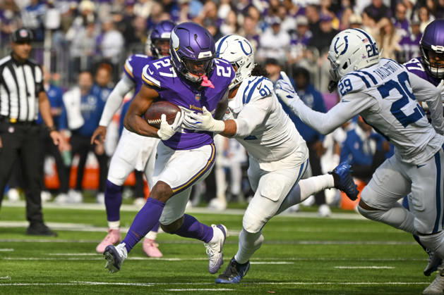 Minnesota Vikings running back Jordan Mason (27) is tackled by Indianapolis Colts defensive end Jaylahn Tuimoloau (91) in the first quarter at U.S. Bank Stadium in Minneapolis, Minnesota on Sunday, October 25, 2026.  MIN20261025107 CRAIGxLASSIG