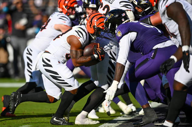 Cincinnati Bengals running back Samaje Perine (34) charges up the middle on a 1 yard touchdown run against Baltimore Ravens linebacker Zion Young (9) during the fourth quarter at M&T Bank Stadium in Baltimore, Maryland, on Sunday, October 25, 2026. Cincinnati won 35-13.  BAL20261025117 DAVIDxTULIS